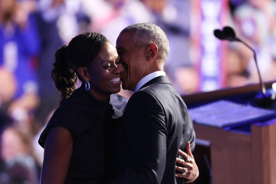 CHICAGO, ILLINOIS - AUGUST 20: Former U.S. President Barack Obama (L) greets former first lady Michelle Obama as he arrives to speak on stage during the second day of the Democratic National Convention at the United Center on August 20, 2024 in Chicago, Illinois. Delegates, politicians, and Democratic Party supporters are gathering in Chicago, as current Vice President Kamala Harris is named her party's presidential nominee. The DNC takes place from August 19-22. (Photo by Win McNamee/Getty Images)