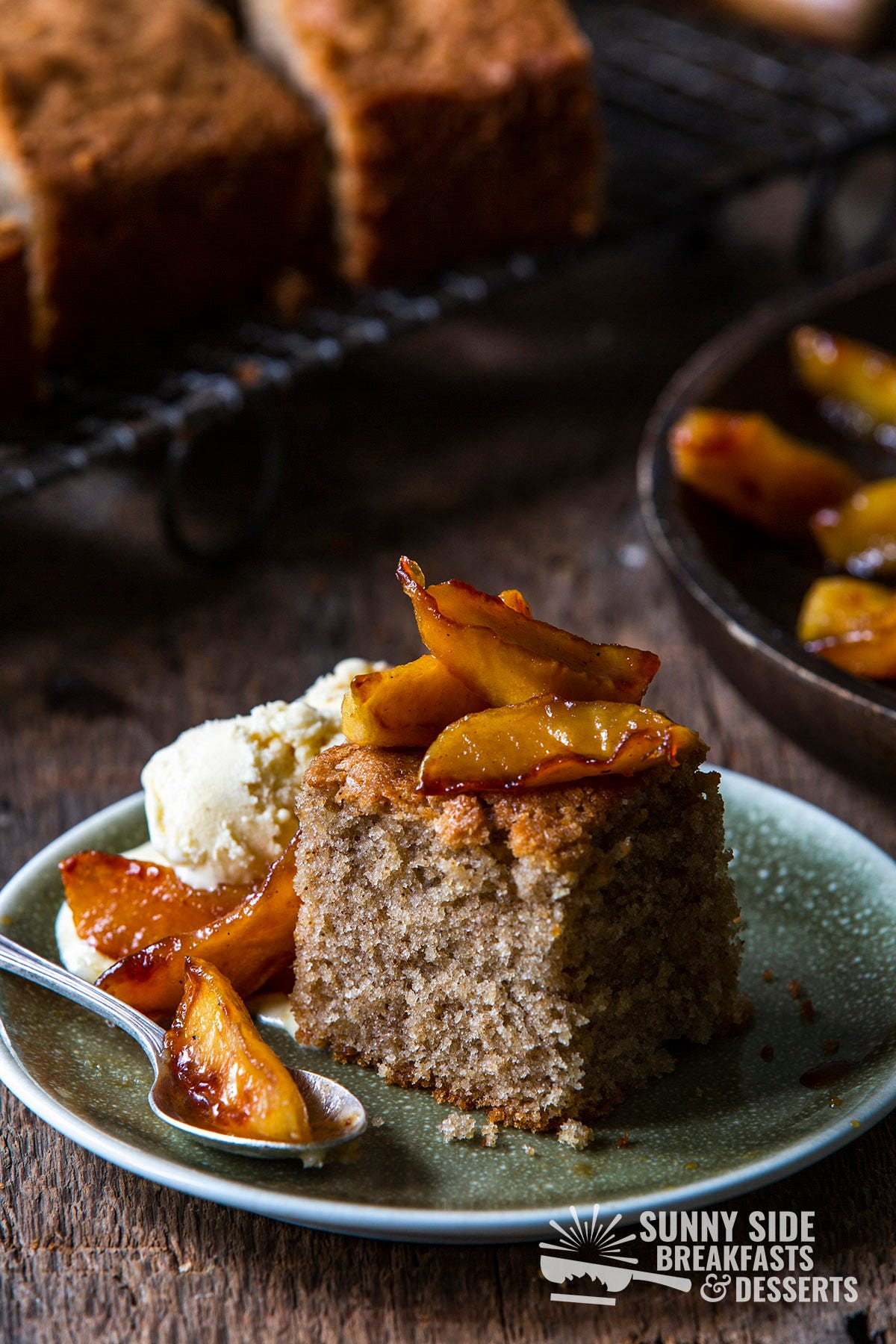 A slice of honey cake with caramelized apples and ice cream.