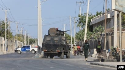 FILE - Security forces patrol outside a building that was attacked by suspected al-Shabab militants in the Somalia's capital Mogadishu on Feb. 21, 2023.