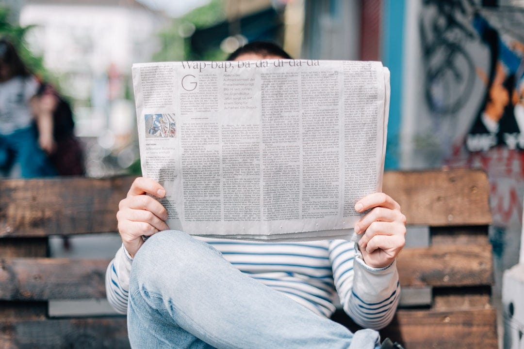 Person reading a newspaper Person reading a newspaper
