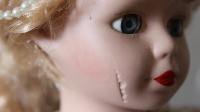 Plastic doll with scar