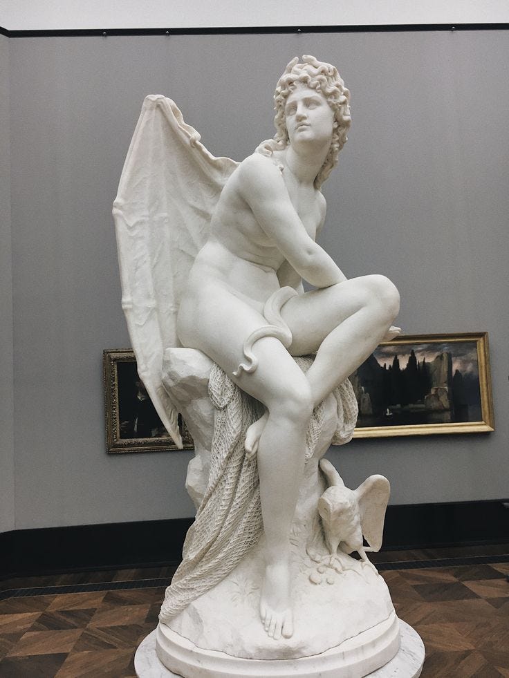 This may contain: a white statue sitting on top of a wooden floor