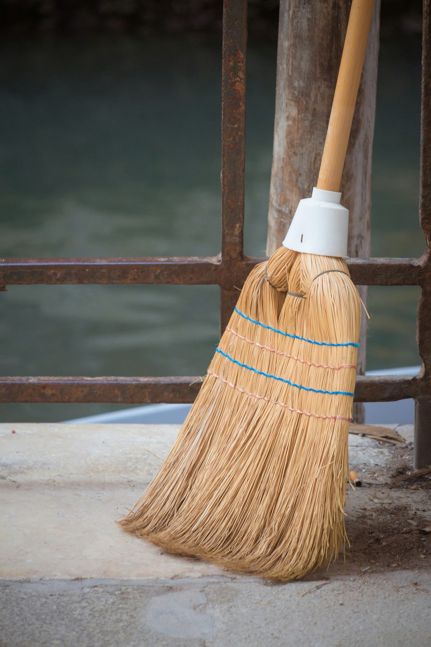 Broom leaning against a porch