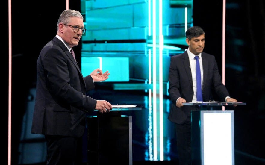 Labour leader Keir Starmer and Conservative leader Rishi Sunak stand onstage at a televised debate.