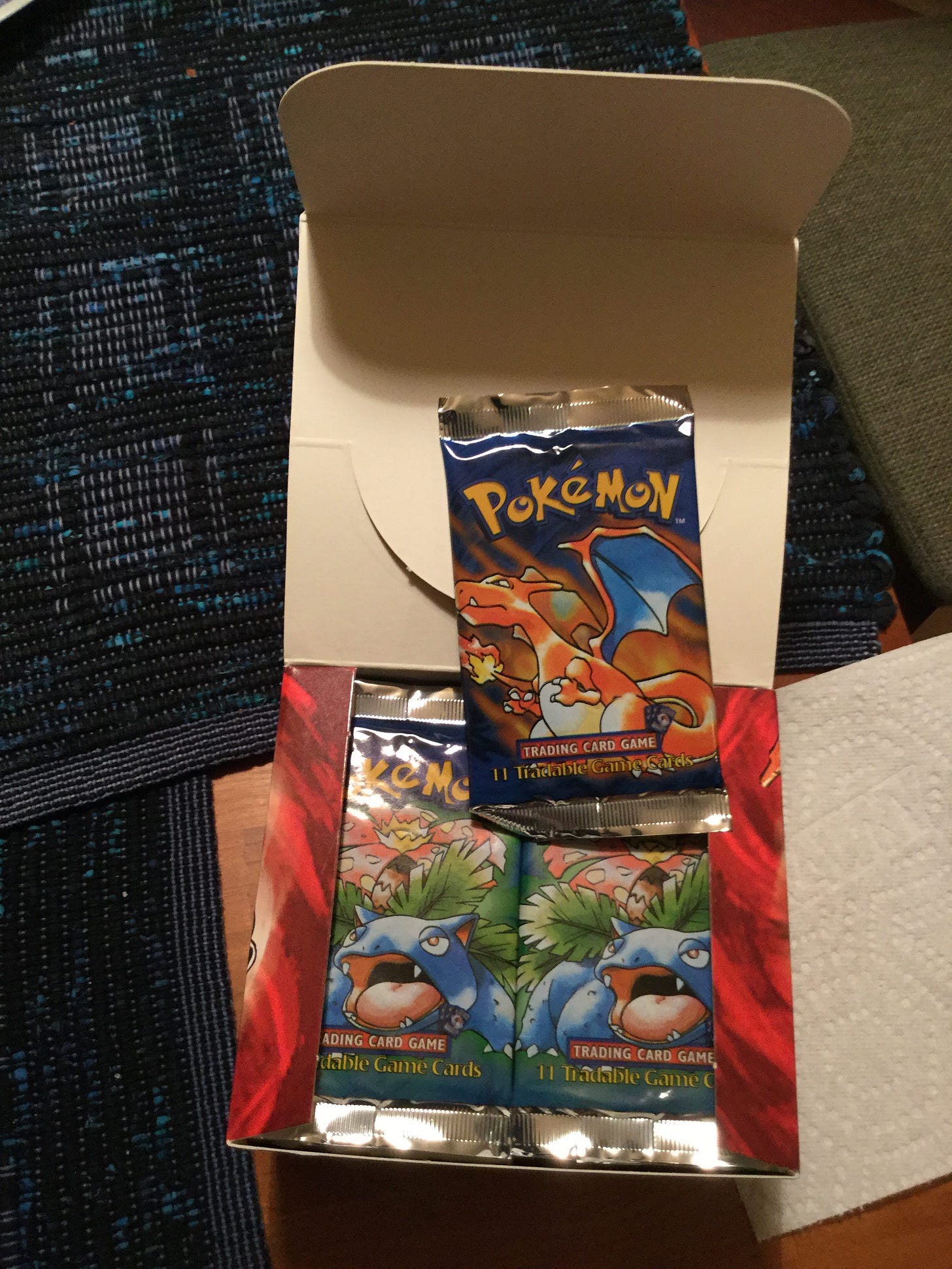 An opened box of shadowless WotC Pokémon booster packs from Carol's personal collection that she sold in 2021. The sale furnished her entire income for that year