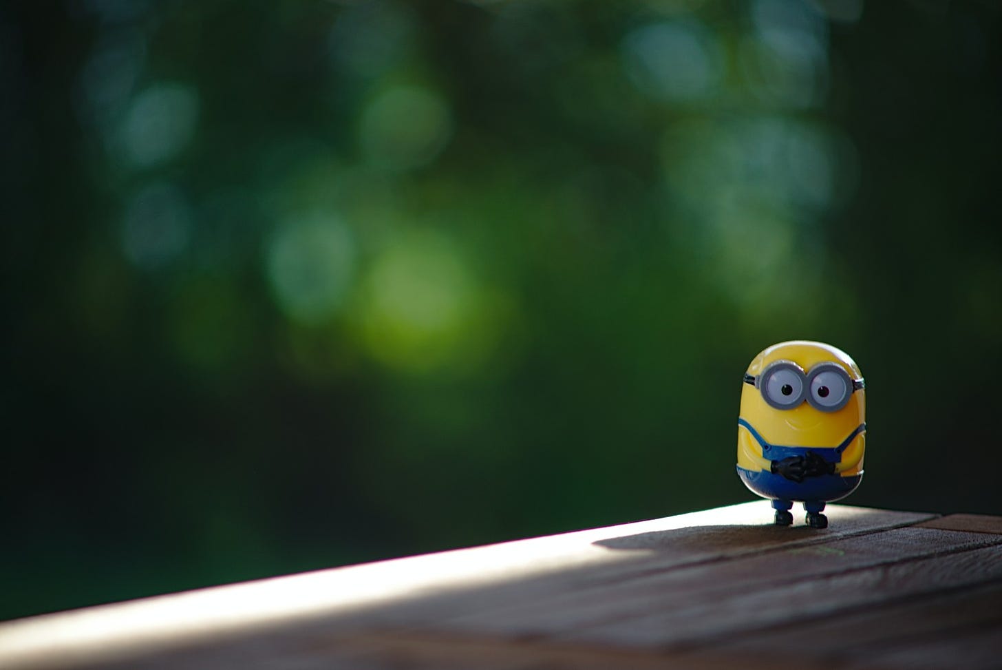 A green field with a minion figurine on it