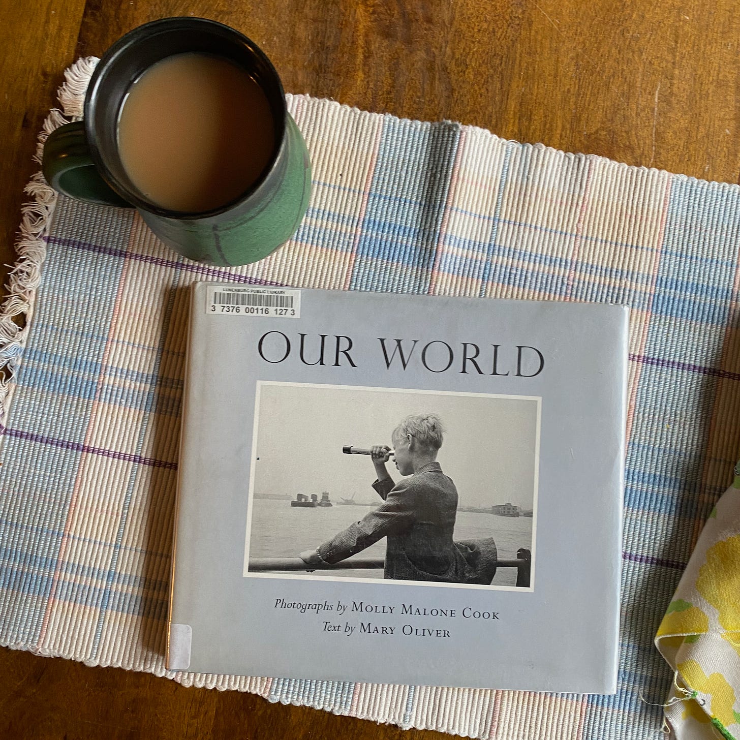 Our world on a woven placemat next to a mug of tea.
