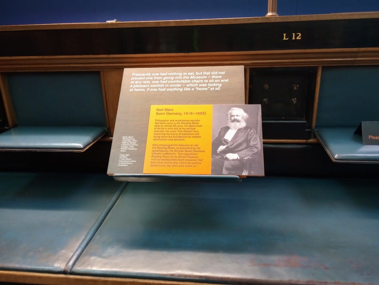 Info panel with photo, quote, and info about Karl Marx, set in an old carrel