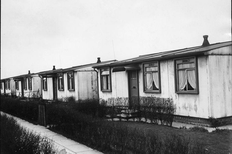 0_A-row-of-prefab-housing-in-Camberley-Road-Hough-End-Estate-Manchester-March-1954.jpg