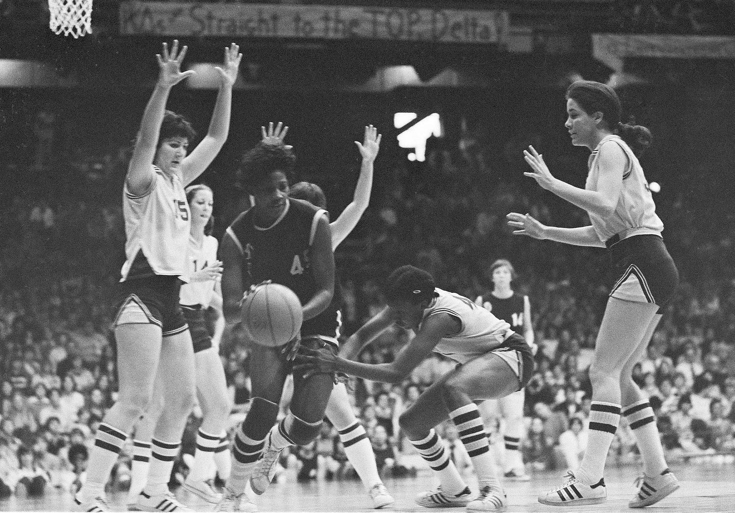 Delta State's Lusia Harris, center, drives through the Louisiana State defense during the AIAW basketball championship game in Minneapolis, Minn., March 26, 1977. Delta State won, 68-55.
