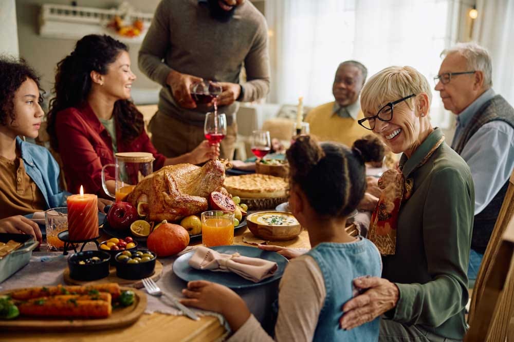 Family and friends gathered around the dinner table for a holiday meal together