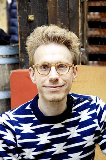 picture of young man with glasses and blue striped shirt