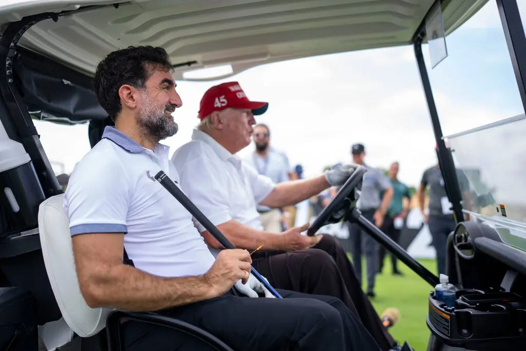 President Trump driving a golf cart with Yasir Al-Rumayyan sitting in the passenger seat.