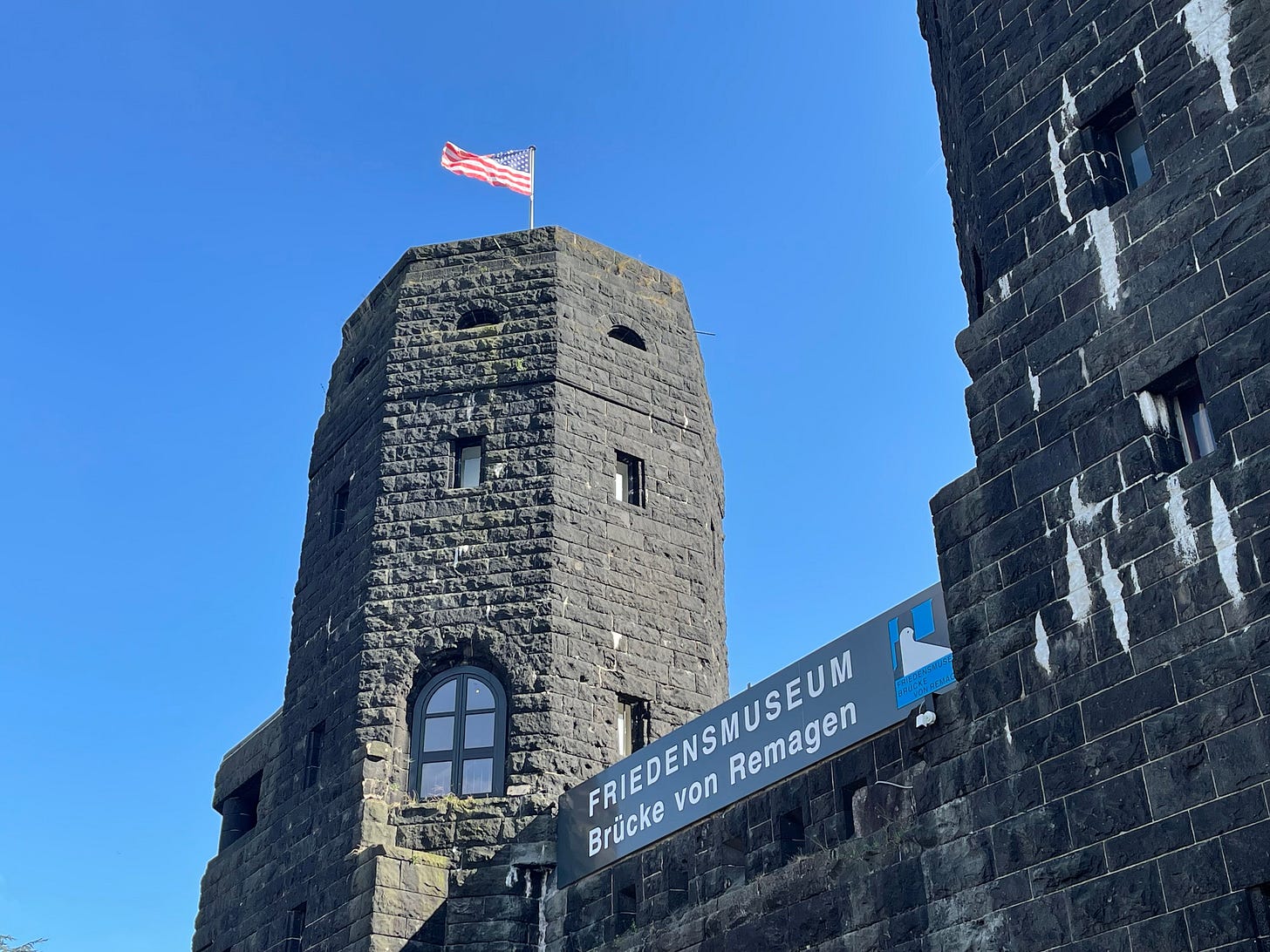 the massive bridge towers that now house the peace museum. On top is the American flag. the massive bridge towers that now house the peace museum. On top is the American flag.