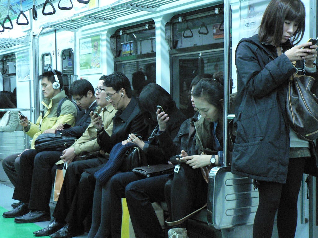 Everyone is staring at their phone, on the Seoul Metro, Se… | Flickr