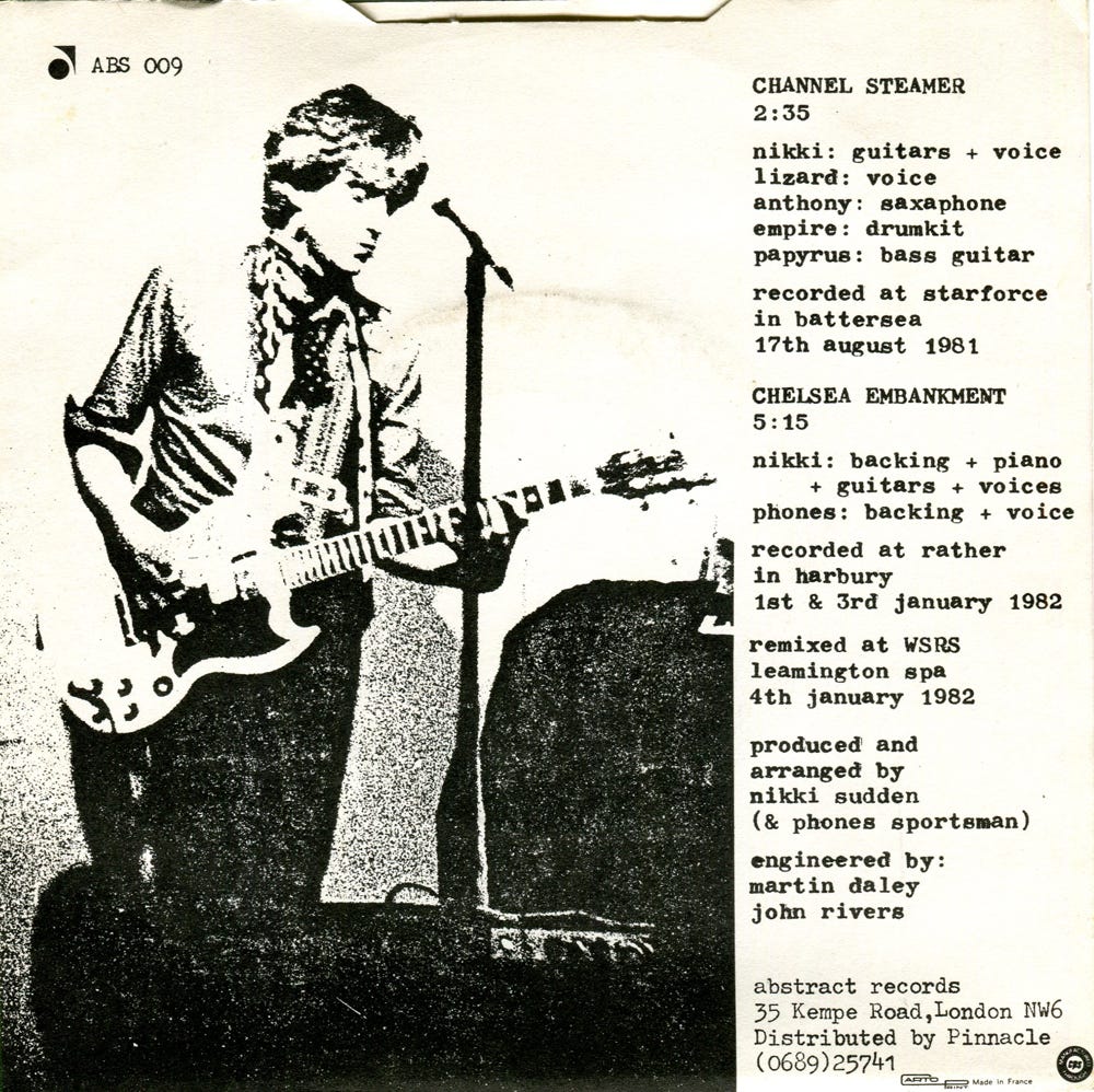 Reverse of the Channel Steamer picture sleeve, with a photo of Nikki playing the guitar.