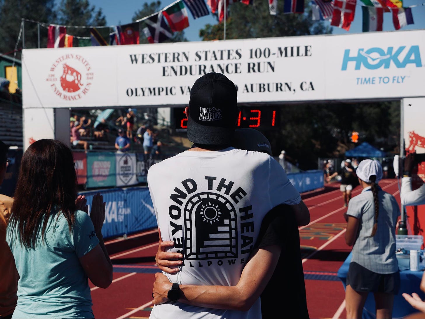 The author at the finish line of the Western States 100 holding his wife lisa in his arms