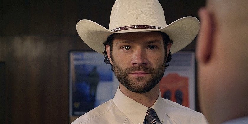 Walker Jared Padalecki smiling looking proud with Rangers white hat.