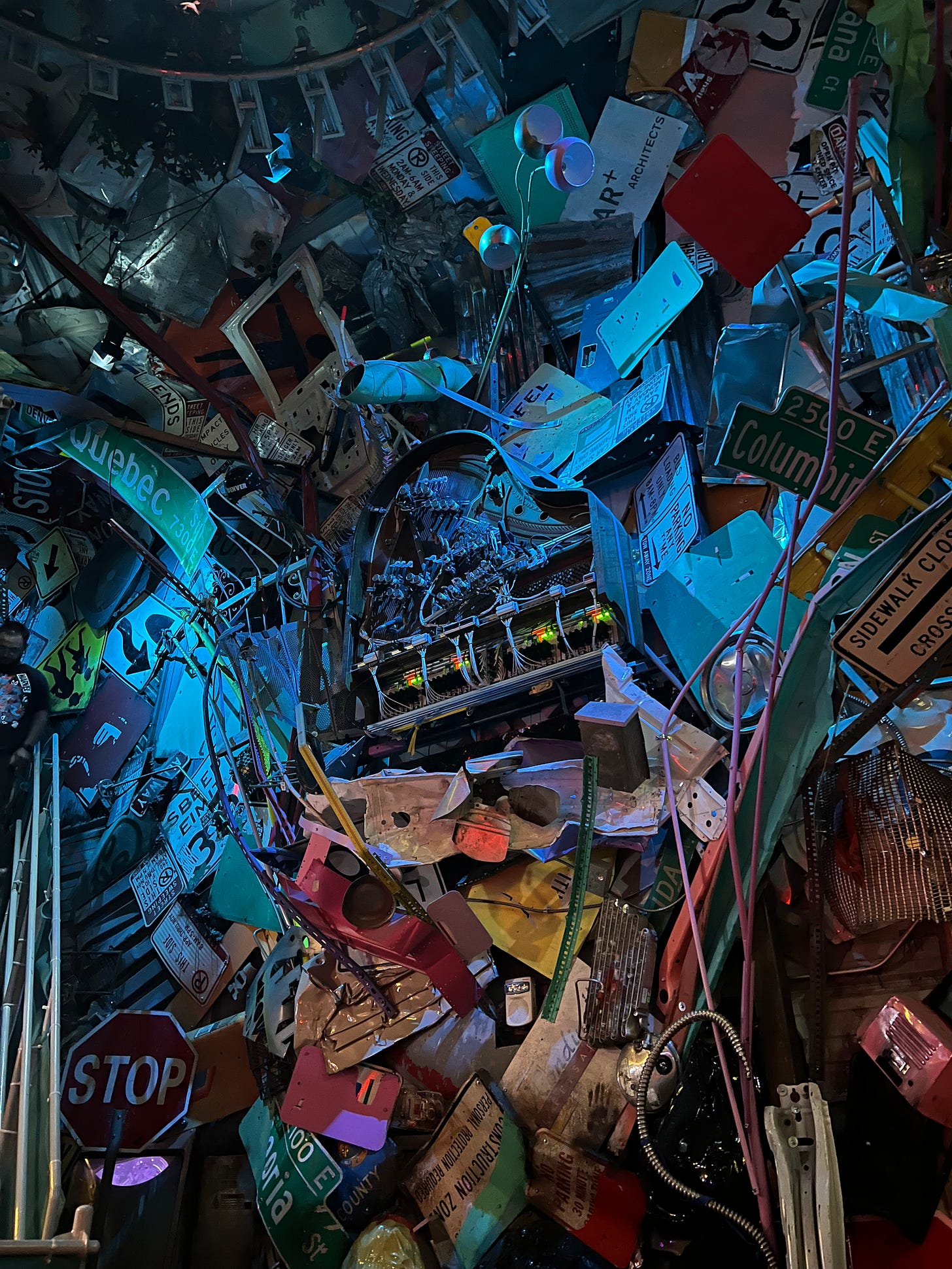 Image of part of the Meow Wolf (Denver) art exhibit, which includes a room full of walls and walls of trash.