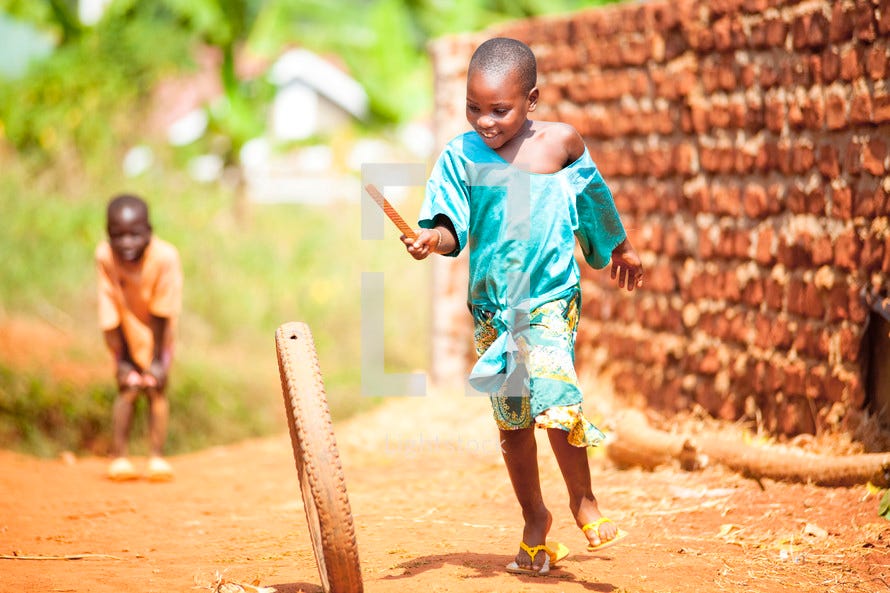 African children playing with bike wheel — Photo — Lightstock