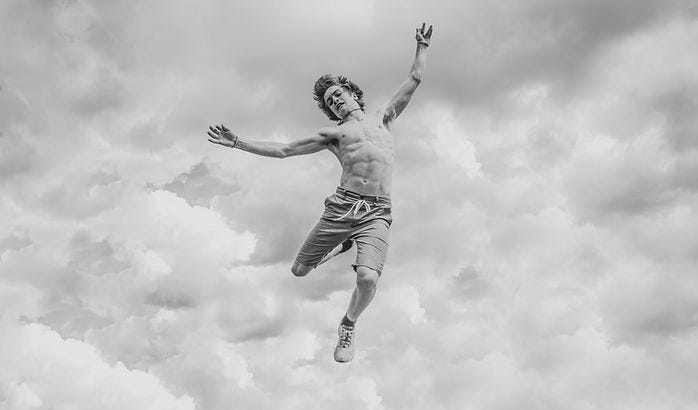 Black and white image of man falling from the sky.
