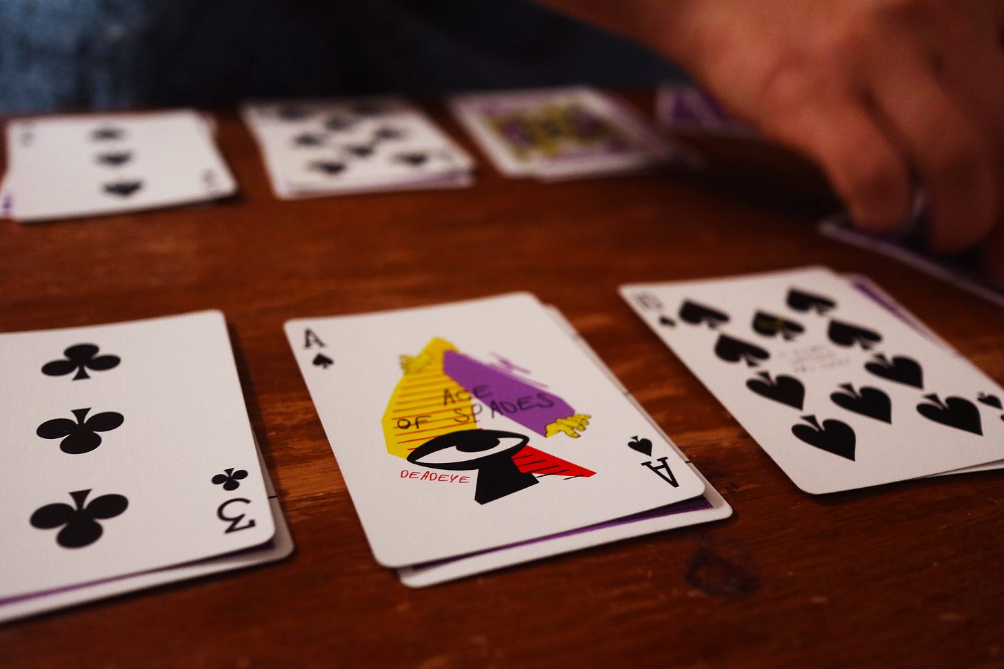 A hand of the card game Shithead, with a colourful ace of spades on show.