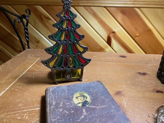 Stained glass Christmas tree on a table with a book