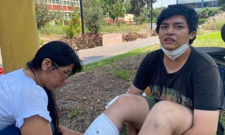Esteban Godofredo, a student, receives treatment for injuries to his leg