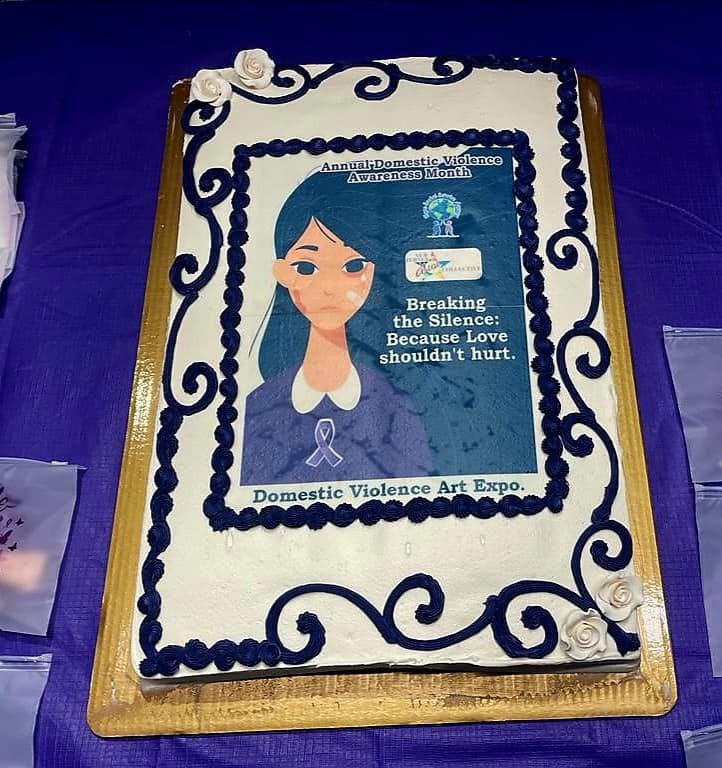 A picure of a recreation of the Hope Social Service Agency's Annual Art Expo. The image shows a manga-style depiction of a woman with long black hair and large dark eyes. Her face is bruised. On her purple blouse theres a purple ribbon in honor of Domestic Violence Awareness Month (October). A picure of a recreation of the Hope Social Service Agency's Annual Art Expo. The image shows a manga-style depiction of a woman with long black hair and large dark eyes. Her face is bruised. On her purple blouse theres a purple ribbon in honor of Domestic Violence Awareness Month (October).