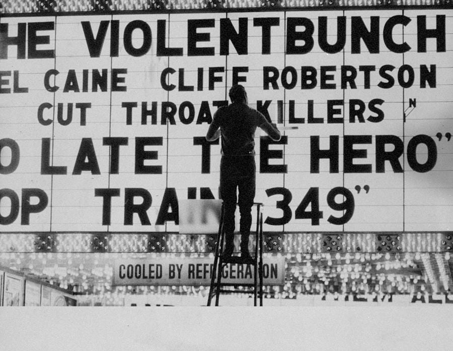 Man Changes Letters On Movie Marquee At by New York Daily News Archive