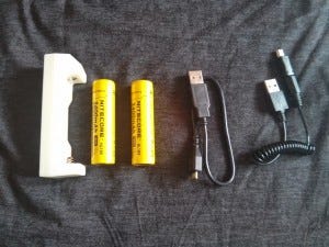 Left to right: ML-102 18650 charger can charge any USB device, two 18650 batteries, my Micro USB cable, and a Mini USB cable for charging the batteries