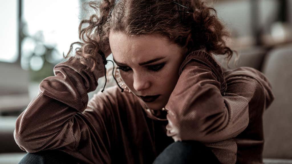 Curly haired teenage girl with dark makeup