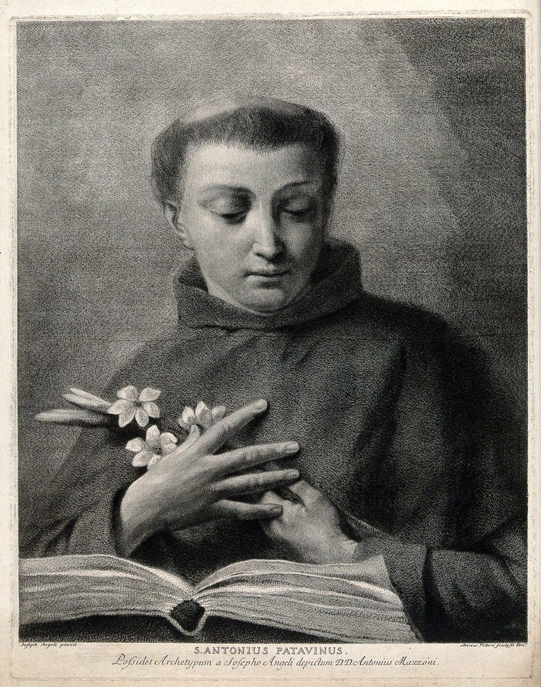 A line engraving of Saint Antony of Padua, his hands holding three flowers and pressing them gently to his heart, while his eyes look down at an open Bible on a table.  By M. Pitteri after G. Angeli.  Part of the Wellcome Collection.