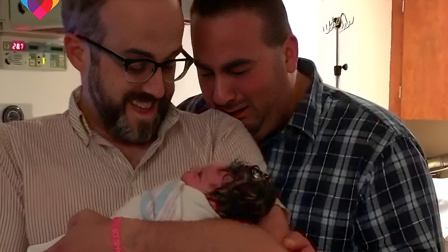 AI enhanced image: Two gay men in a hospital. One is holding a baby while the other is overwhelmed with emotion.