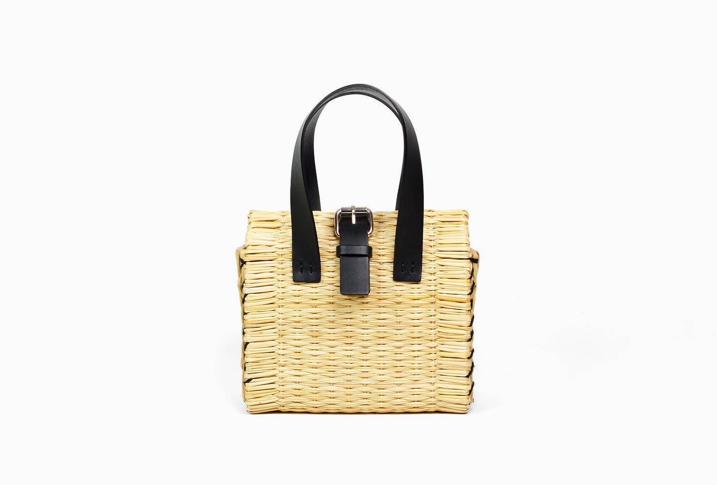 Front view of the all-natural handwoven soft-rush straw clutch with a sleek black leather strap closure.