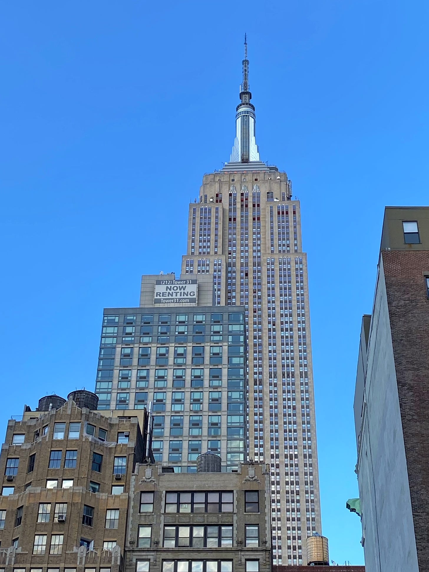 Four water towers on the roofs of the buildings south of the Empire State Building, standing in the rear of the shot.