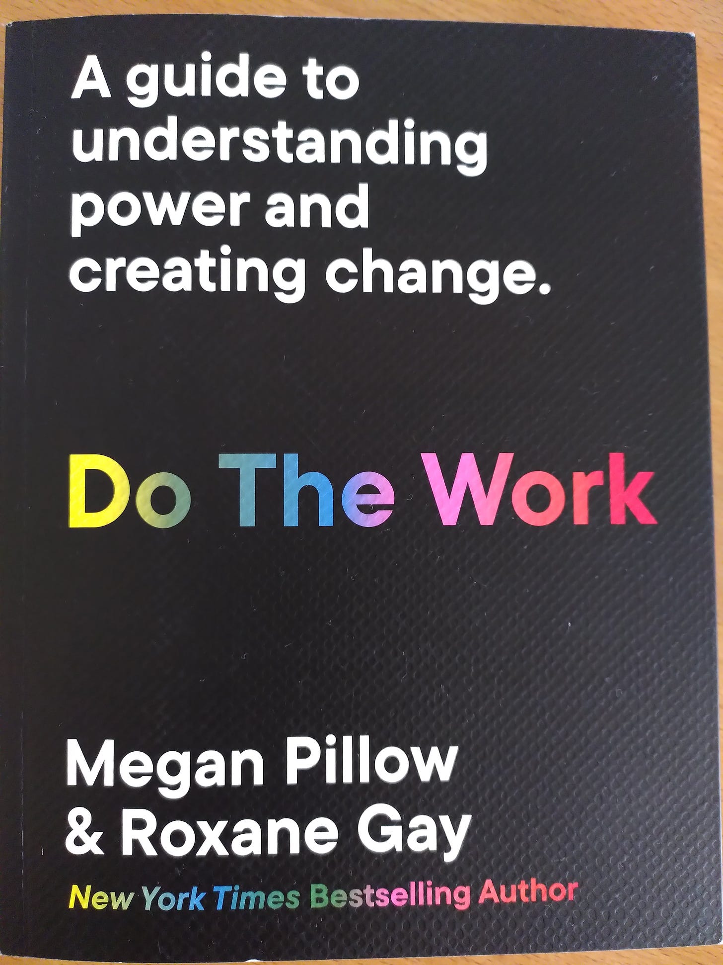 Book cover: Black background, bold white: "A guide to understanding power and creating change. In rainbow block letters: Do The Work. 