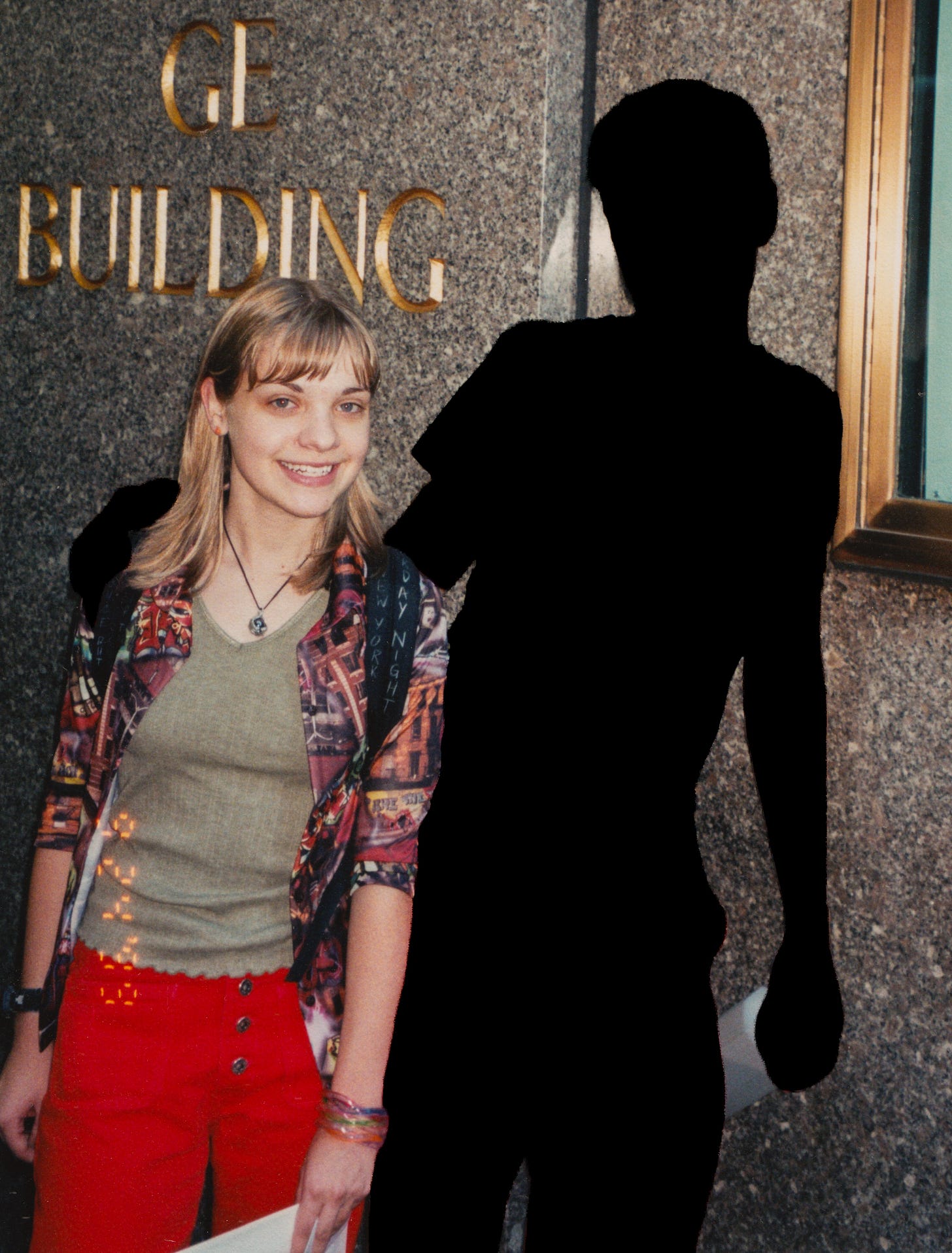 My brother and I outside of 30 Rock in NYC. I am 15. He is silhouetted.