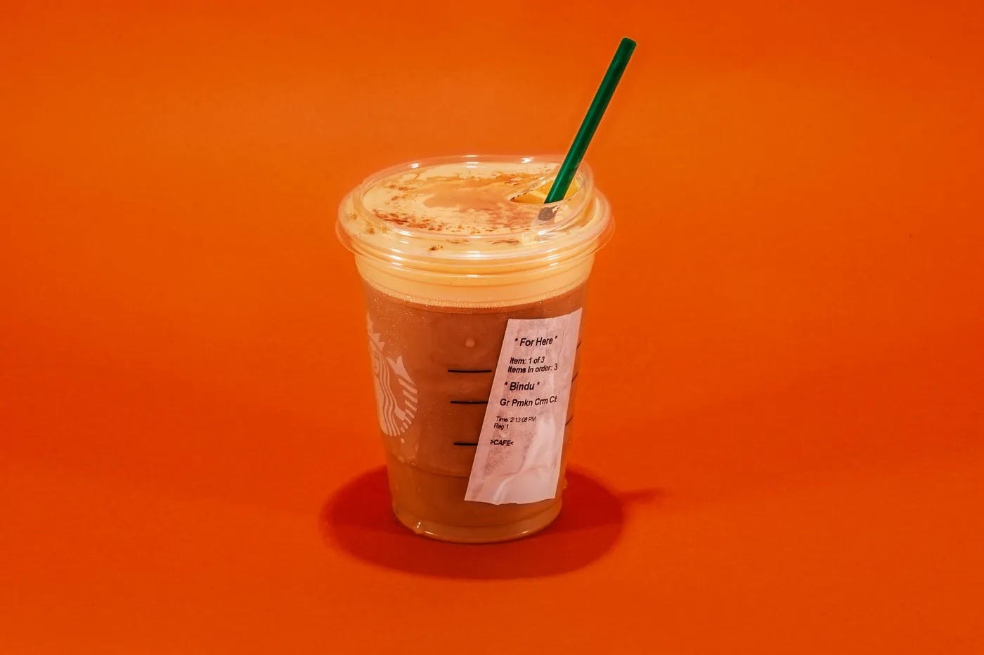 A cold brew Starbucks PSL; outside of the drink is sweaty and the label is all damp