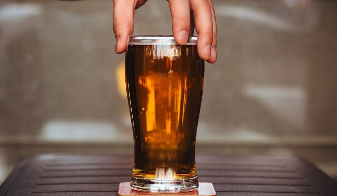 person holding glass cup