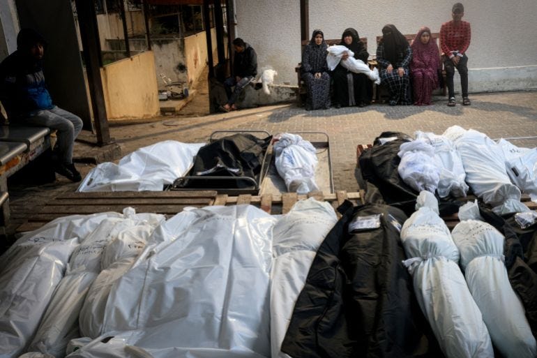 Relativaes mourn Muhannad Ashour (background), the youngest of victims from the same family killed in Israeli bombardment Relativaes mourn Muhannad Ashour (background), the youngest of victims from the same family killed in Israeli bombardment