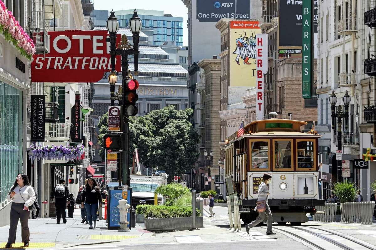 A Powell Street cable car makes its way past Union Square in San Francisco. Mayor London Breed and other city officials announced a plan for a $6 million investment in the downtown cable car turnaround area.