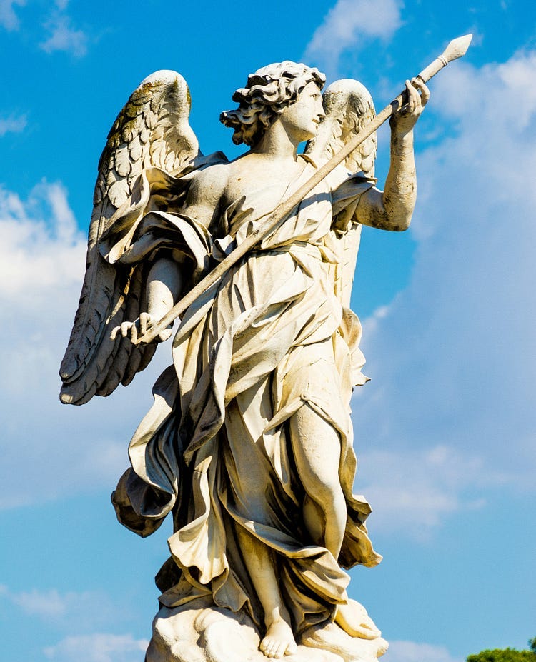 statue of an angel against a blue sky