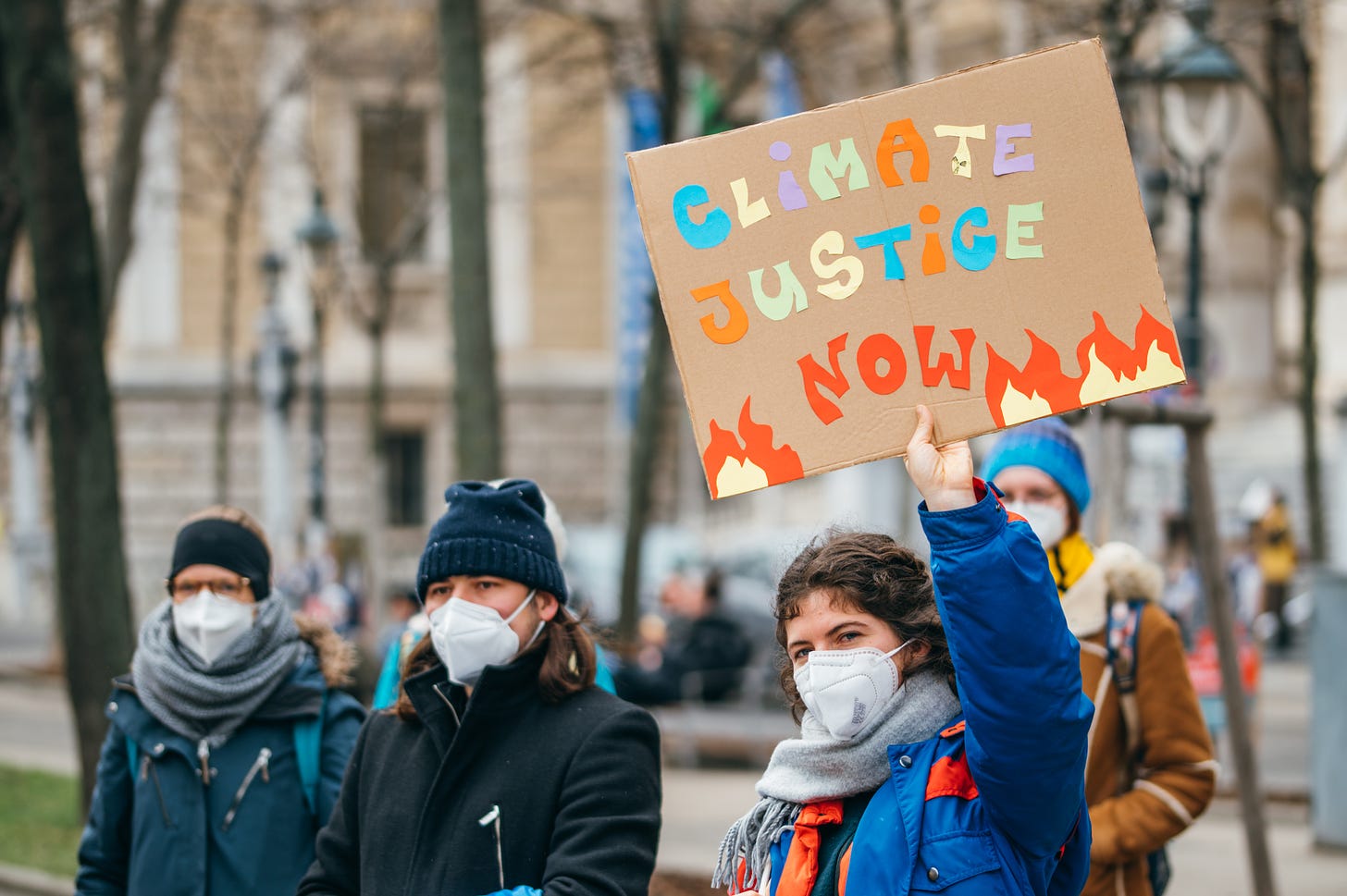 File:Protester holding a sign with "Climate Justice Now" message at a  Global Climate Strike (51058381908).jpg - Wikimedia Commons