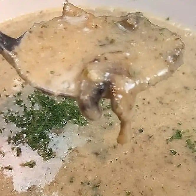 Boil & Blend Creamy Mushroom Soup a spoonful with a mushroom slice on the edge of the spoon