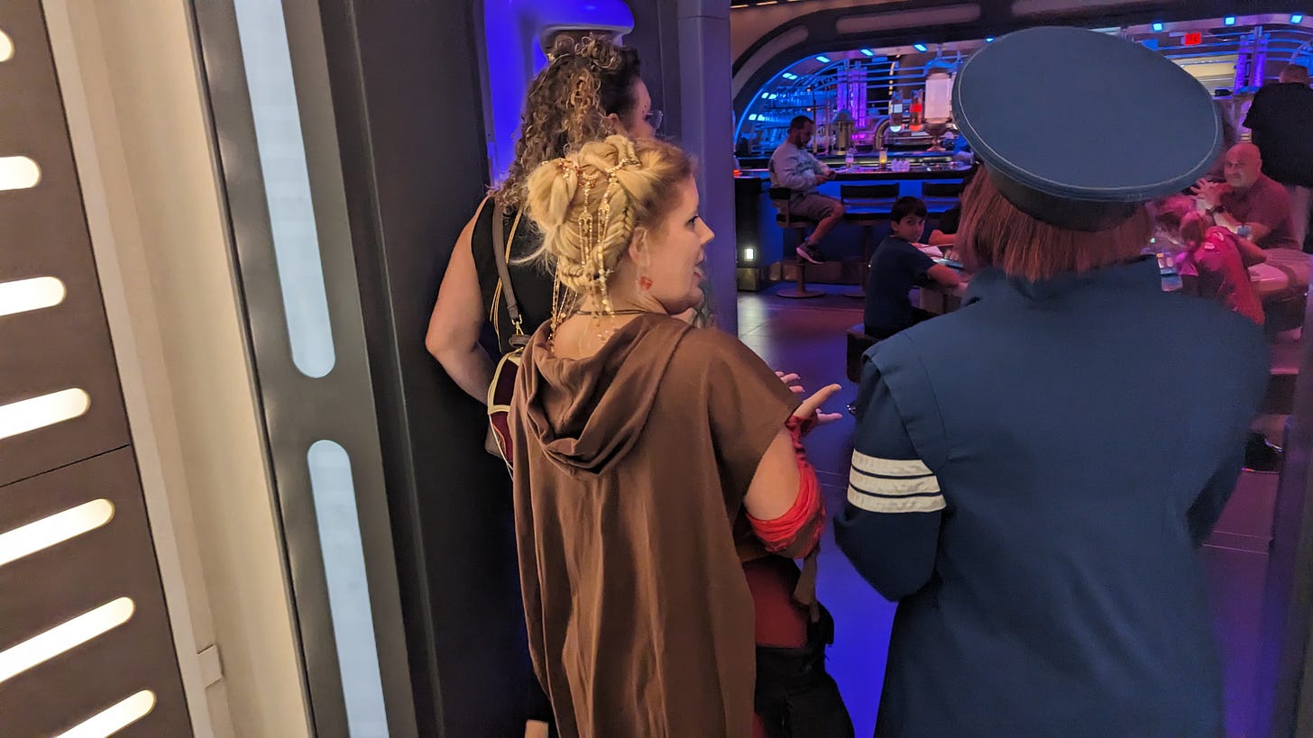 Cass with the Captain, standing in the doors of the Sublight Lounge