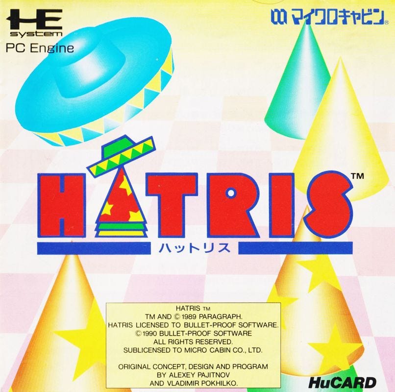 A scan of the box art for the PC Engine edition of Hatris, which features a variety of hats on-screen, with a couple of them looking as if they're about to be stacked onto the "A" in the Hatris logo.