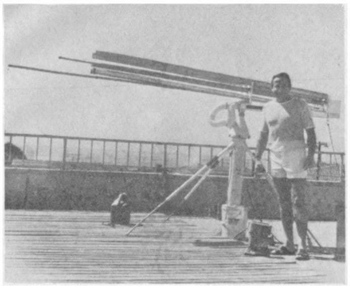 This photo shows Trevor James Constable with the MK II version of the weather control unit emplaced during tests on a San Pedro, California, rooftop. Time-lapse films made during tests proved the device to be capable of dissipating clouds more rapidly than any other unit designed by the California investigator. MK II features radionic tuning, a new step.