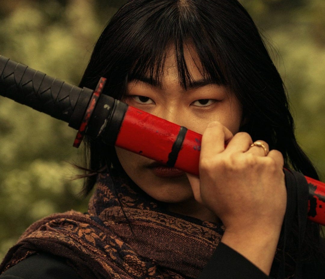 a woman holding a red umbrella over her face a woman holding a red umbrella over her face