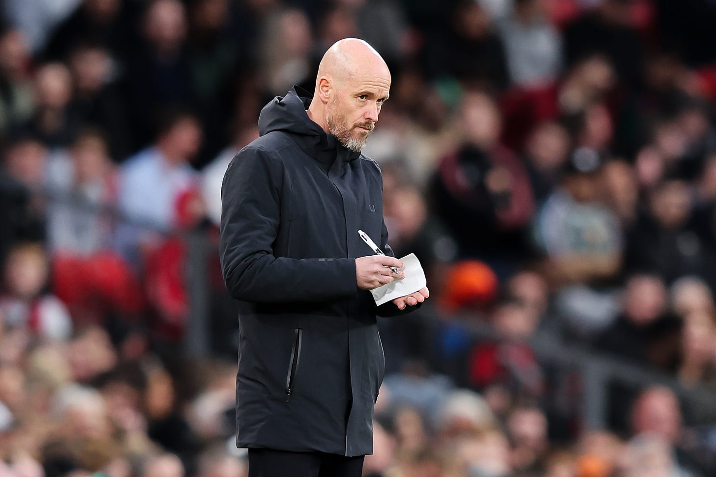 Erik ten Hag pictured making notes during Manchester United's 4-2 win over Sheffield United in April 2024